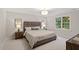 Serene bedroom with neutral color scheme, plush bedding, and ample natural light at 9425 Brimstone Ln, Raleigh, NC 27613