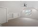 Bright bonus room with vaulted ceiling, built in shelves and neutral carpet at 9425 Brimstone Ln, Raleigh, NC 27613