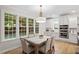 Charming dining area filled with natural light, features hardwood floors, and modern decor at 9425 Brimstone Ln, Raleigh, NC 27613