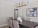 Dining room with modern chandelier, seating for six and abstract art on the wall at 9425 Brimstone Ln, Raleigh, NC 27613