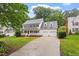 Charming two-story home features a welcoming front porch, an attached two-car garage, and a well-manicured lawn at 9425 Brimstone Ln, Raleigh, NC 27613