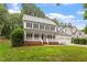 Beautiful two-story home boasts a welcoming front porch and lush green lawn at 9425 Brimstone Ln, Raleigh, NC 27613