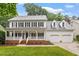 Inviting two-story home with a charming front porch and a two-car garage at 9425 Brimstone Ln, Raleigh, NC 27613