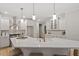 Bright, modern kitchen with stainless steel appliances and a large quartz island at 9425 Brimstone Ln, Raleigh, NC 27613