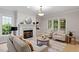 Sunlit living room features fireplace, stylish decor, and comfortable seating at 9425 Brimstone Ln, Raleigh, NC 27613