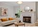 Bright living room features marble fireplace, contemporary decor, and ample natural light at 9425 Brimstone Ln, Raleigh, NC 27613