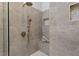 Close up of modern shower with gray tile, dual shower heads, bench, and storage niche at 9425 Brimstone Ln, Raleigh, NC 27613