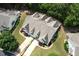 An aerial view of a well-maintained home showcasing a two-car garage, dormer windows, and manicured landscaping at 100 Sheraton Ln, Garner, NC 27529