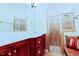 This bathroom has double sinks, cherry cabinets, and a glass enclosed shower with a bench at 100 Sheraton Ln, Garner, NC 27529