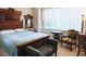 Comfortable bedroom featuring a decorative wood bed frame, soft lighting, and a cozy seating area at 100 Sheraton Ln, Garner, NC 27529