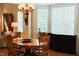 Bright dining area with hardwood floors, wooden chairs, a modern light fixture, and built in cabinet at 100 Sheraton Ln, Garner, NC 27529