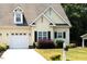 Charming home featuring an attached garage, well-maintained lawn, and complemented by established landscaping at 100 Sheraton Ln, Garner, NC 27529