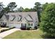 Well-kept home with dormer windows, a neatly trimmed lawn, and a side-entry garage on a sunny day at 100 Sheraton Ln, Garner, NC 27529