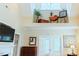 Spacious living room with a fireplace, high ceilings, a decorative ledge, and elegant glass doors at 100 Sheraton Ln, Garner, NC 27529