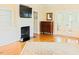 Inviting living room with a fireplace, built-in shelving, hardwood floors, and decorative glass doors at 100 Sheraton Ln, Garner, NC 27529