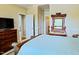 This main bedroom has an ensuite bath, a dresser with television, and doorways to other parts of the home at 100 Sheraton Ln, Garner, NC 27529