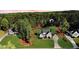 Stunning aerial view of a modern home surrounded by lush landscaping and mature trees at 104 Crosby Ln, Sanford, NC 27330