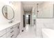 Modern bathroom with a glass-enclosed shower, soaking tub, and sleek vanity at 104 Crosby Ln, Sanford, NC 27330