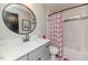 Stylish bathroom featuring gray cabinets, modern black fixtures, and a shower-tub combo at 104 Crosby Ln, Sanford, NC 27330