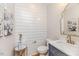 Stylish powder room features a modern vanity, shiplap accent wall and elegant decor at 104 Crosby Ln, Sanford, NC 27330