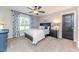 Cozy bedroom featuring plush carpet, modern ceiling fan, and a serene window view at 104 Crosby Ln, Sanford, NC 27330