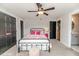Comfortable bedroom featuring plush carpet, modern fan, and contemporary black doors at 104 Crosby Ln, Sanford, NC 27330