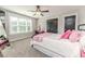 Well-lit bedroom with plush carpet, contemporary ceiling fan, and modern black doors at 104 Crosby Ln, Sanford, NC 27330