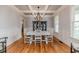 Formal dining room showcasing hardwood floors, decorative chandelier, wainscotting, and classic white table set at 104 Crosby Ln, Sanford, NC 27330