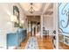 Inviting foyer with hardwood floors, a coffered ceiling, blue cabinet, staircase, and an open view to the living spaces at 104 Crosby Ln, Sanford, NC 27330