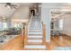 Inviting foyer with hardwood floors, staircase, and views into the living room and dining area at 104 Crosby Ln, Sanford, NC 27330