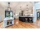Bright kitchen features a center island, stainless steel appliances, hardwood floors and modern pendant lighting at 104 Crosby Ln, Sanford, NC 27330
