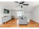 Bright living room with hardwood floors, a comfortable sofa, and a modern ceiling fan at 104 Crosby Ln, Sanford, NC 27330