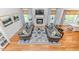 Open-concept living space featuring hardwood floors, large windows, a fireplace, and tastefully coordinated decor at 104 Crosby Ln, Sanford, NC 27330