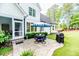 Outdoor patio featuring a dining set, grill, and well-manicured lawn at 104 Crosby Ln, Sanford, NC 27330