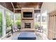 Cozy sunroom with brick fireplace, comfortable seating, and natural light at 104 Crosby Ln, Sanford, NC 27330