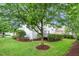 Backyard with lush greenery, mature trees, and a cozy wooden deck, perfect for outdoor living at 106 Roundtop Rd, Cary, NC 27519