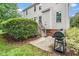 Backyard featuring mature landscaping, a grill, and a small deck at 106 Roundtop Rd, Cary, NC 27519
