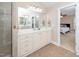 Bright bathroom with a double vanity and a view of the connected bedroom at 106 Roundtop Rd, Cary, NC 27519