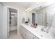 Bright bathroom with a double sink vanity, large mirror, and a shower and tub combination at 106 Roundtop Rd, Cary, NC 27519