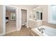 Spacious bathroom featuring a soaking tub, vanity with sink, and tile flooring at 106 Roundtop Rd, Cary, NC 27519