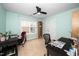 Well-lit bedroom featuring neutral walls, a ceiling fan, and two desk spaces for work or study at 106 Roundtop Rd, Cary, NC 27519