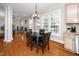 Bright breakfast nook featuring hardwood floors, large windows, and an exterior view of the outdoors at 106 Roundtop Rd, Cary, NC 27519