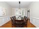Elegant dining room with hardwood floors, chair rail detail, and a stylish chandelier at 106 Roundtop Rd, Cary, NC 27519