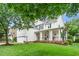 Charming two-story home featuring a welcoming front porch and well-manicured lawn and two-car garage at 106 Roundtop Rd, Cary, NC 27519