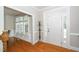 Bright foyer featuring hardwood floors, elegant trim, and a welcoming front door with sidelights at 106 Roundtop Rd, Cary, NC 27519