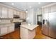 Cozy kitchen with granite countertops, stainless steel appliances, and central island at 106 Roundtop Rd, Cary, NC 27519