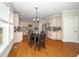 Open kitchen features light wood cabinetry, stainless steel appliances, and a modern dining table at 106 Roundtop Rd, Cary, NC 27519