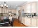 Traditional eat-in kitchen with wood cabinets, granite counters, stainless appliances, and hardwood floors at 106 Roundtop Rd, Cary, NC 27519