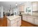 Open concept kitchen with granite countertops, a central island, and stainless steel appliances at 106 Roundtop Rd, Cary, NC 27519