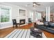 Bright living room featuring hardwood floors, a fireplace, large windows, and neutral paint at 106 Roundtop Rd, Cary, NC 27519